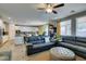 Open concept living room with a view into a modern kitchen featuring stainless steel appliances at 6470 Crest Estates St, Las Vegas, NV 89131
