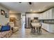 Open floor plan showcasing the living room flowing into the kitchen area with white cabinets at 6470 Crest Estates St, Las Vegas, NV 89131