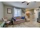 Cozy living room space with wood-look floors, a ceiling fan, and comfortable seating at 6470 Crest Estates St, Las Vegas, NV 89131