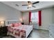 Comfortable bedroom with wood-look flooring, ceiling fan and coordinated furnishings at 6470 Crest Estates St, Las Vegas, NV 89131