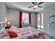 Bedroom featuring wood look floors, red accents and a slider to the outdoor space at 6470 Crest Estates St, Las Vegas, NV 89131