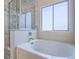 Bathroom with bathtub, glass-enclosed shower, and tub faucet, ideal for relaxation and convenience at 6709 Barrington Hills St, Las Vegas, NV 89149