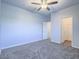 Spacious bedroom with neutral carpet and a ceiling fan has easy access to closets at 6709 Barrington Hills St, Las Vegas, NV 89149