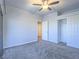 Bright bedroom features neutral carpet, a ceiling fan, and a convenient closet at 6709 Barrington Hills St, Las Vegas, NV 89149