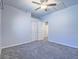 Bedroom with neutral carpet, ceiling fan, and a closet, offering functional and comfortable living at 6709 Barrington Hills St, Las Vegas, NV 89149