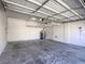 Spacious garage with ceiling storage, overhead lighting, and concrete floor at 6709 Barrington Hills St, Las Vegas, NV 89149
