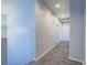 Hallway with carpet flooring, neutral wall color, and recessed lighting, creating a bright and inviting transition space at 6709 Barrington Hills St, Las Vegas, NV 89149