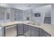 Open kitchen with granite countertops, stainless steel dishwasher, and views into the living room at 6709 Barrington Hills St, Las Vegas, NV 89149