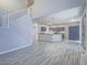 Bright, open-concept living room with staircase and tile flooring at 6709 Barrington Hills St, Las Vegas, NV 89149