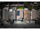 Aerial view of a home with solar panels, green backyard with patio and outdoor dining set at 6973 Pacific Coast St, Las Vegas, NV 89148