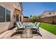 Backyard patio featuring an outdoor dining set and artificial grass at 6973 Pacific Coast St, Las Vegas, NV 89148