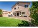Expansive backyard featuring artificial grass, a patio, and views of the surrounding neighborhood at 6973 Pacific Coast St, Las Vegas, NV 89148