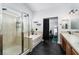 Stylish bathroom with a separate shower and tub, wood cabinets and modern fixtures at 6973 Pacific Coast St, Las Vegas, NV 89148