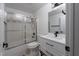 Clean bathroom featuring a shower over tub with a sliding glass door and updated vanity at 6973 Pacific Coast St, Las Vegas, NV 89148