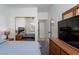 Bedroom with a large mirrored closet door and view into another bedroom at 6973 Pacific Coast St, Las Vegas, NV 89148