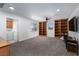 Spacious bonus room with carpet flooring, built-in bookshelves, and a ceiling fan at 6973 Pacific Coast St, Las Vegas, NV 89148