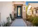 Inviting front entrance with a decorative glass door and well-maintained landscaping at 6973 Pacific Coast St, Las Vegas, NV 89148