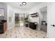Bright eat-in kitchen featuring tile flooring and access to the backyard through sliding glass doors at 6973 Pacific Coast St, Las Vegas, NV 89148