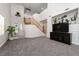 Large living area with stairs, featuring gray carpet and a decorative mantle at 6973 Pacific Coast St, Las Vegas, NV 89148