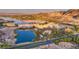 Scenic aerial view showcasing the resort-style community with lake, buildings, and lush landscaping at 7 Hilltop Crest St, Henderson, NV 89011