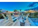 Outdoor seating around fire pit by custom pool offers luxurious relaxation against a desert sunset backdrop at 7 Hilltop Crest St, Henderson, NV 89011