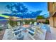 Cozy backyard with a fire pit, pool, and comfortable Adirondack chairs perfect for enjoying evenings outdoors at 7 Hilltop Crest St, Henderson, NV 89011