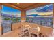 Enjoy beautiful sunset views from this cozy covered balcony with comfortable seating at 7 Hilltop Crest St, Henderson, NV 89011