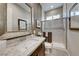 Elegant bathroom with a granite countertop, modern fixtures, and a walk-in shower at 7 Hilltop Crest St, Henderson, NV 89011