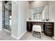 Bathroom vanity area featuring a large mirror and tiled floors, along with a walk-in shower at 7 Hilltop Crest St, Henderson, NV 89011