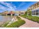 Picturesque exterior view featuring a waterside walkway, a bridge, and building exteriors with lush landscaping at 7 Hilltop Crest St, Henderson, NV 89011