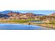Picturesque golf course featuring lush green fairways, water features, and mountain views at 7 Hilltop Crest St, Henderson, NV 89011