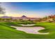 Beautifully maintained golf course with sand traps and views of the desert mountains in the distance at 7 Hilltop Crest St, Henderson, NV 89011