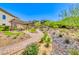 Inviting green space featuring a shaded pergola with seating surrounded by lush landscaping and a scenic pathway at 7 Hilltop Crest St, Henderson, NV 89011