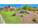 Beautifully landscaped green space with turf and shrubs accentuating the community feel at 7 Hilltop Crest St, Henderson, NV 89011