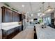 Well-equipped kitchen with dark cabinets, stainless steel appliances and a large island at 7 Hilltop Crest St, Henderson, NV 89011