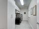 Well-organized laundry room with ample storage, modern appliances, and neutral colors at 7 Hilltop Crest St, Henderson, NV 89011