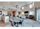 Spacious open-concept living room with a stone fireplace, soaring ceilings, and large windows at 7 Hilltop Crest St, Henderson, NV 89011