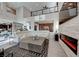 Spacious living room with a stone fireplace, high ceilings, and a large white sectional sofa at 7 Hilltop Crest St, Henderson, NV 89011