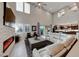 Bright, open living room with a fireplace, high ceilings, and a large white sectional sofa at 7 Hilltop Crest St, Henderson, NV 89011