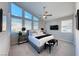 Bright main bedroom featuring large windows, neutral decor, and a ceiling fan at 7 Hilltop Crest St, Henderson, NV 89011