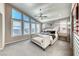 Bright main bedroom features large windows, plantation shutters, ceiling fan, and neutral decor at 7 Hilltop Crest St, Henderson, NV 89011