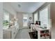 Bright home office features plantation shutters, built-in desk and shelving, and neutral paint at 7 Hilltop Crest St, Henderson, NV 89011