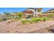 Charming picnic area with a pergola, table, and artificial turf amid a beautifully landscaped walking path at 7 Hilltop Crest St, Henderson, NV 89011