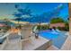 Backyard features a relaxing pool, cozy fire pit, comfortable lounge chairs with beautiful sunset views at 7 Hilltop Crest St, Henderson, NV 89011