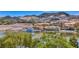 Scenic waterfront view featuring lakeside buildings, boat docks, and mountain views, showcasing the community lifestyle at 7 Hilltop Crest St, Henderson, NV 89011