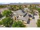Stunning aerial view of a two-story home with a gray roof, solar panels, and lush landscaping at 7460 Grassy Field Ct, Las Vegas, NV 89131