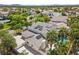 Beautiful aerial view of home with solar panels, pool, and palm trees at 7460 Grassy Field Ct, Las Vegas, NV 89131