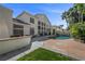 Expansive backyard with pool, outdoor kitchen, mature landscaping, and large windows for ample natural light at 7460 Grassy Field Ct, Las Vegas, NV 89131