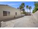 Large concrete backyard perfect for entertaining, complemented by tall palm trees and partial fencing at 7460 Grassy Field Ct, Las Vegas, NV 89131