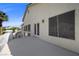 Balcony with white railing and French doors overlooking greenery and neighborhood homes at 7460 Grassy Field Ct, Las Vegas, NV 89131